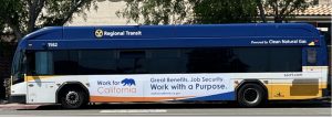Regional Transit bus number 1562 with 'Work for California' advertisement featuring state bear logo and text about job benefits and security